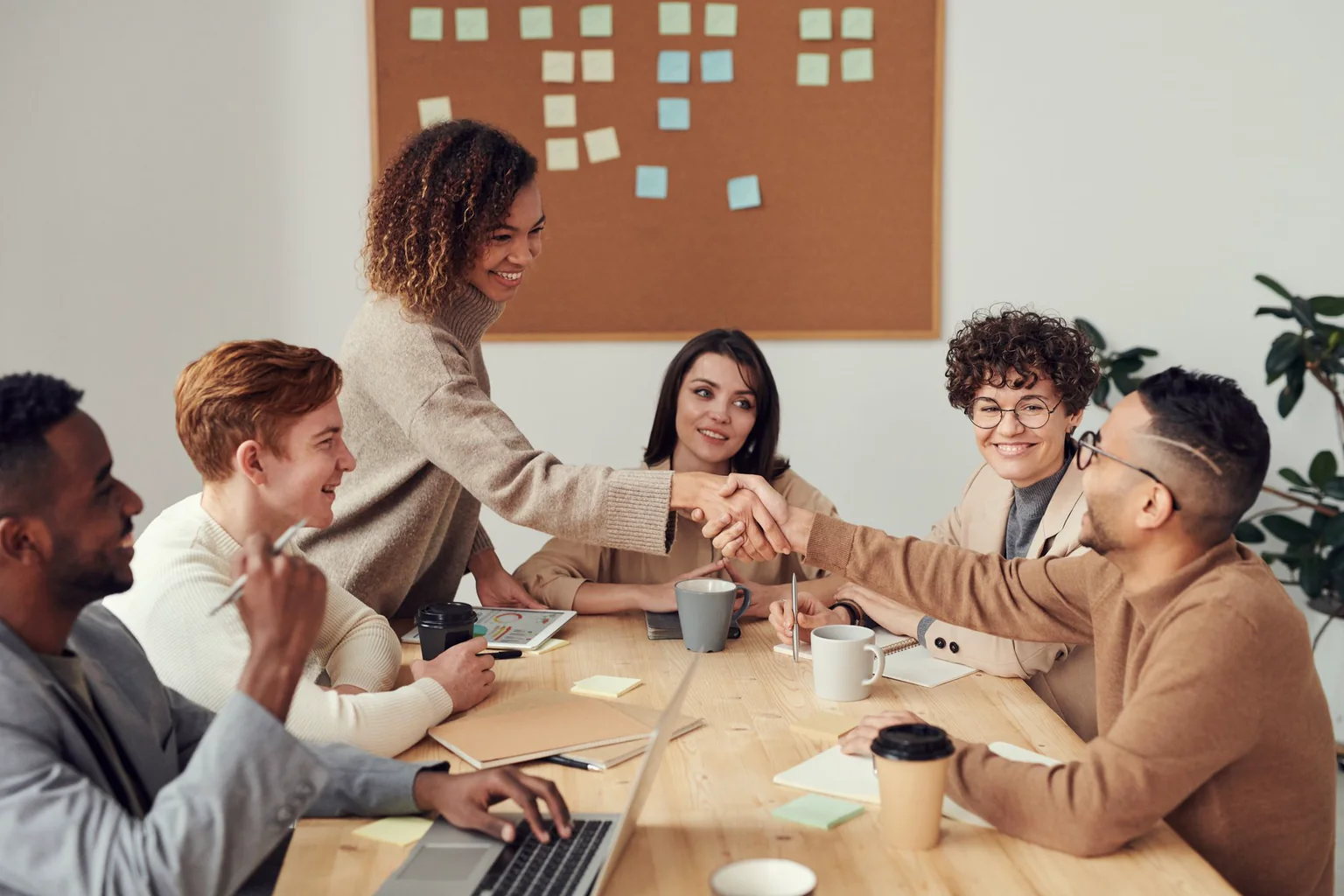 Equipo profesional conversa alrededor de una mesa durante una reunión