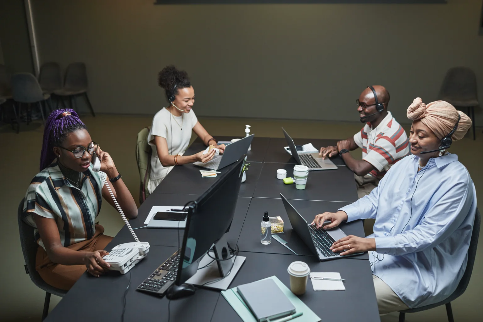 Equipo de atención al cliente trabaja con auriculares en una oficina